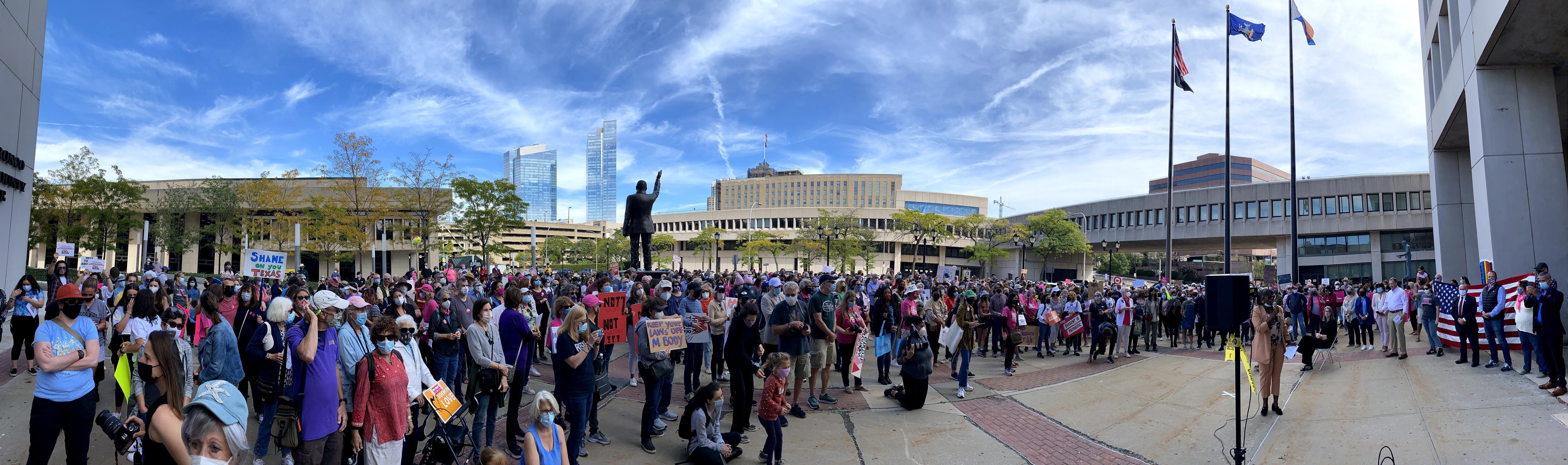 Community members at White Plains rally showing democratic engagement